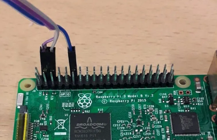 Jumper wires connected to the GPIO header of a Raspberry Pi