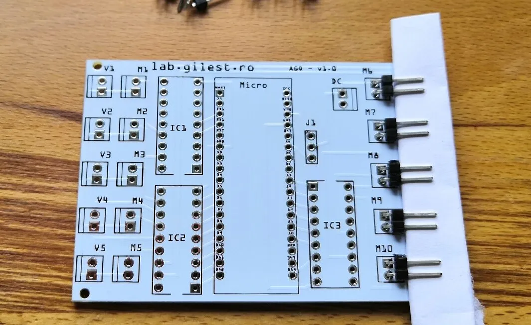 Module board with right-angled headers held at a slight upward angle by a fold of paper