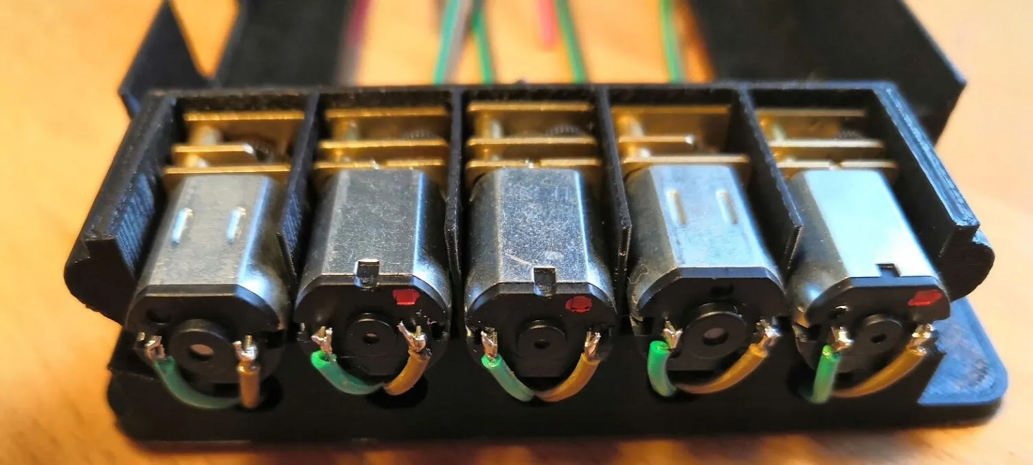 Five motors in their slots on one side of the holder